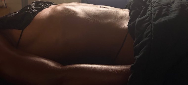 Client's midsection before a lymphatic drainage session, showing visible bloating